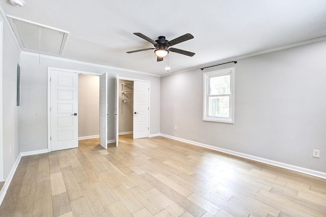 1052 Yorktown Dr, Charleston, SC 29412 - unfurnished bedroom with attic access, light wood-style flooring, crown molding, ceiling fan, and a closet