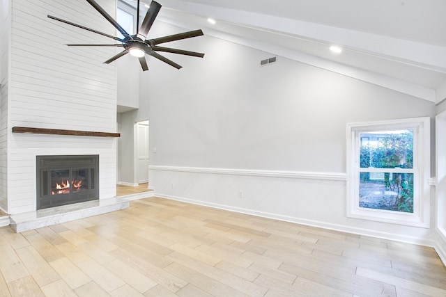 1052 Yorktown Dr, Charleston, SC 29412 - unfurnished living room with high vaulted ceiling, beamed ceiling, a ceiling fan, light wood-style flooring, and a large fireplace