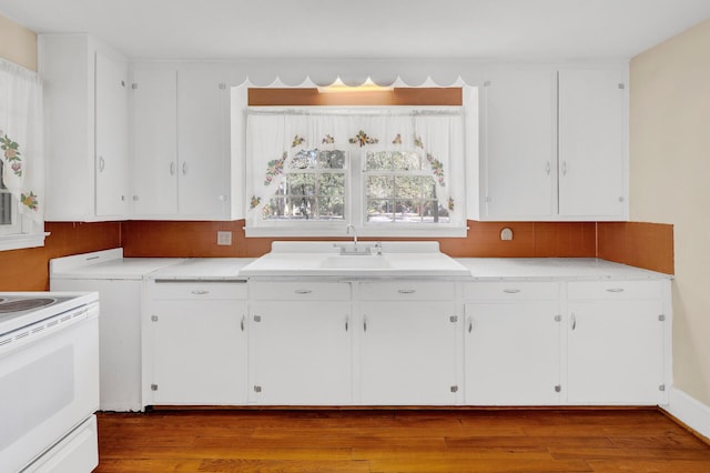 kitchen featuring white cabinetry, light countertops, electric stove, and wood finished floors