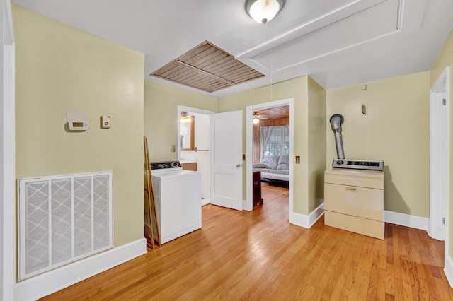 interior space featuring baseboards, light wood finished floors, washer / clothes dryer, and visible vents