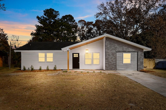 ranch-style home featuring a yard