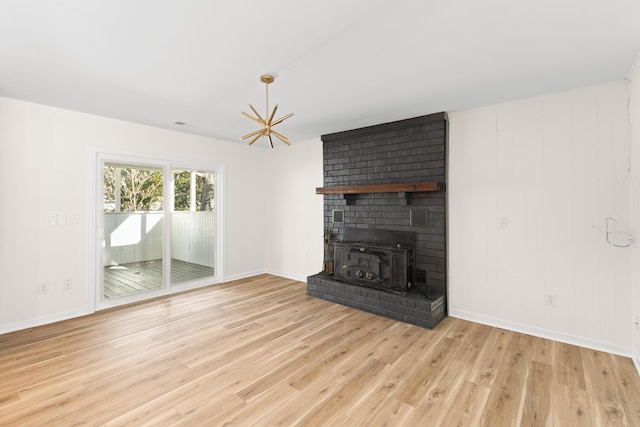 unfurnished living room featuring a fireplace and light hardwood / wood-style flooring