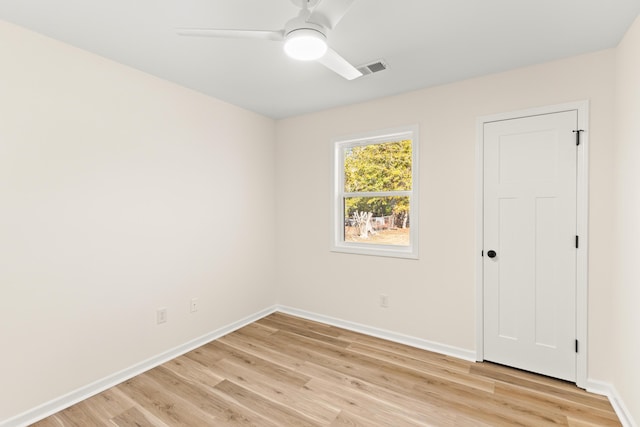 empty room with ceiling fan and light hardwood / wood-style floors