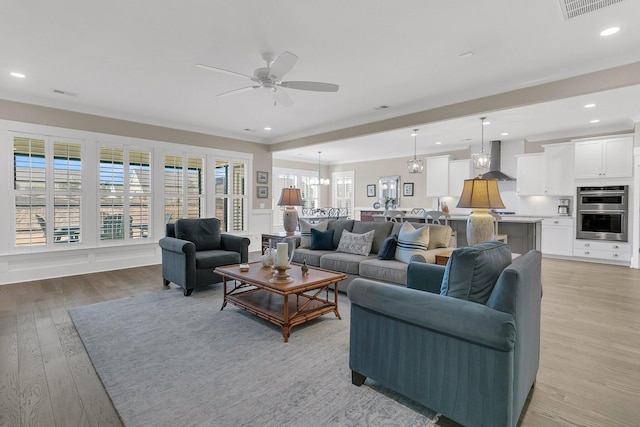 living room with ceiling fan and light wood-type flooring