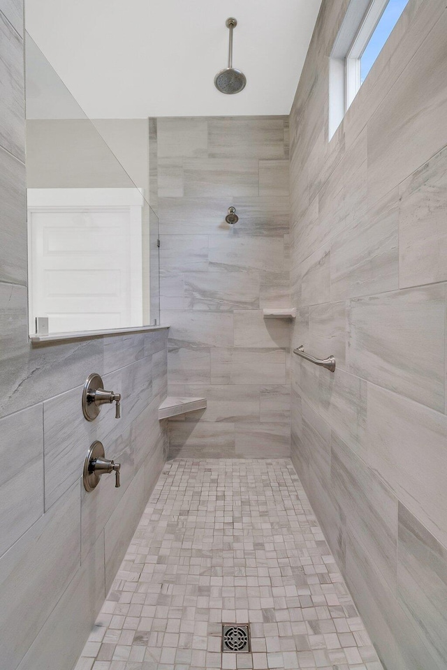 bathroom with a tile shower