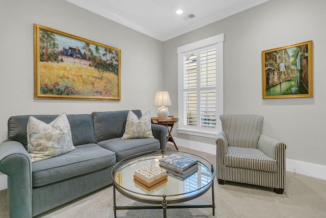 living room featuring ornamental molding, plenty of natural light, and carpet