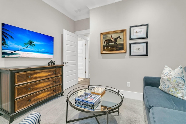 living room with ornamental molding and light colored carpet