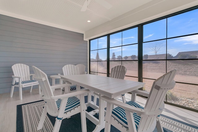 sunroom / solarium featuring ceiling fan