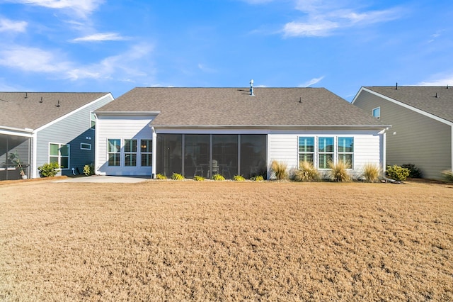 rear view of house featuring a patio, a sunroom, and a yard