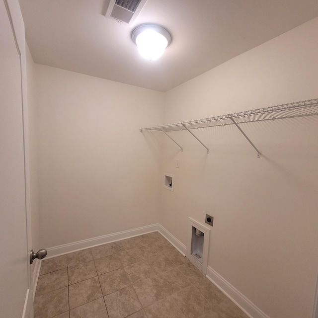 clothes washing area with hookup for a washing machine, hookup for an electric dryer, laundry area, visible vents, and baseboards