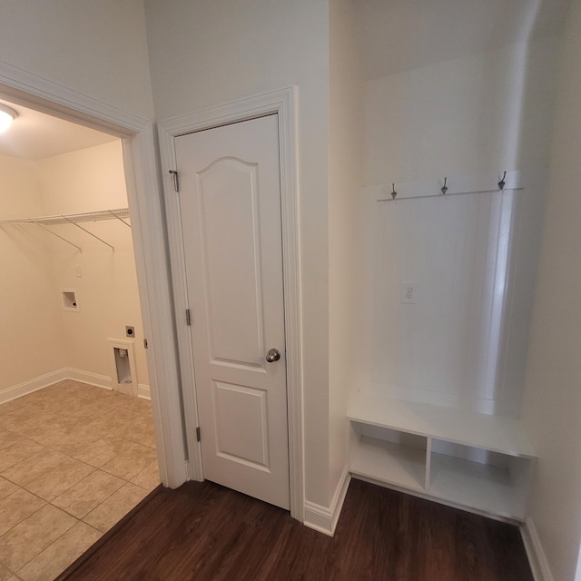 mudroom featuring dark wood-style floors and baseboards