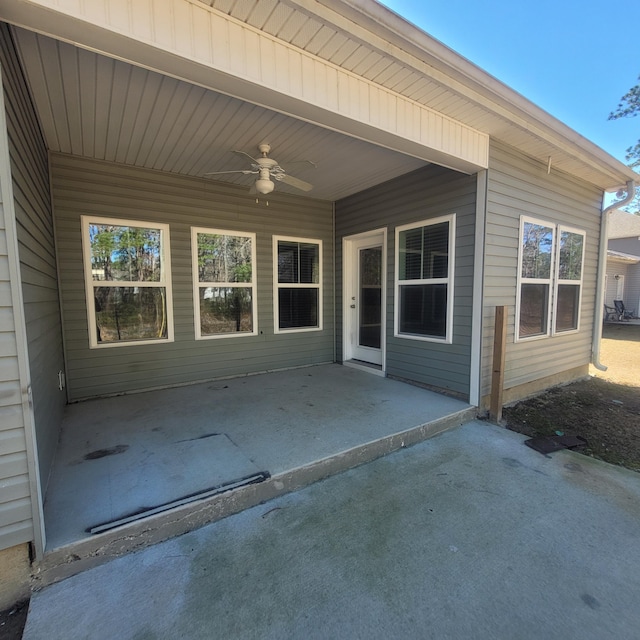 view of exterior entry with a patio and ceiling fan