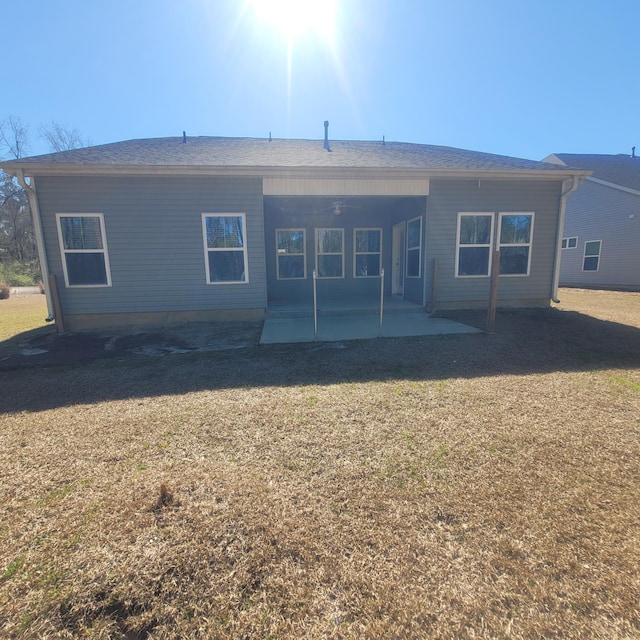 back of house with ceiling fan, a lawn, and a patio