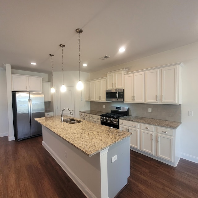 kitchen featuring appliances with stainless steel finishes, white cabinets, and a sink