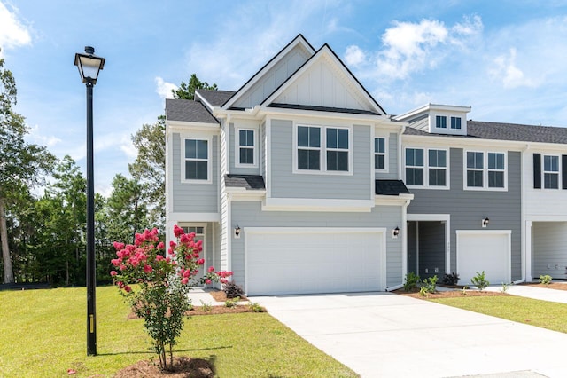 view of front of home featuring a front yard and a garage