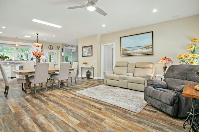 living room featuring wood-type flooring and ceiling fan