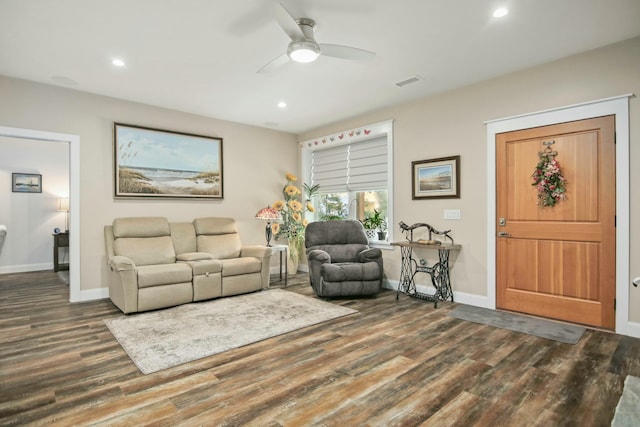 living room featuring ceiling fan and dark hardwood / wood-style floors