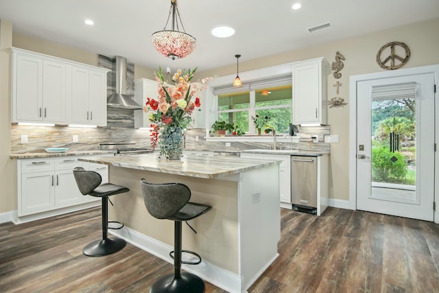 kitchen featuring white cabinets, wall chimney exhaust hood, a center island, and dark hardwood / wood-style floors