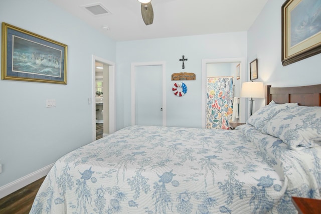 bedroom with dark hardwood / wood-style flooring, ceiling fan, and connected bathroom