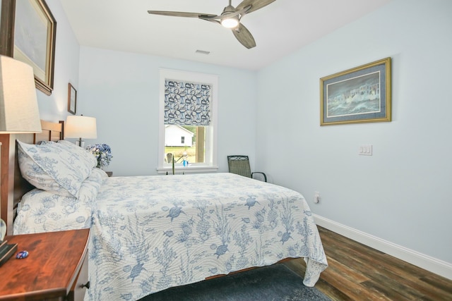 bedroom with ceiling fan and dark hardwood / wood-style floors