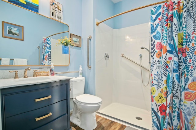 bathroom featuring toilet, hardwood / wood-style floors, vanity, and a shower with shower curtain