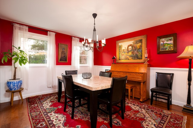 dining room featuring dark hardwood / wood-style floors and a notable chandelier