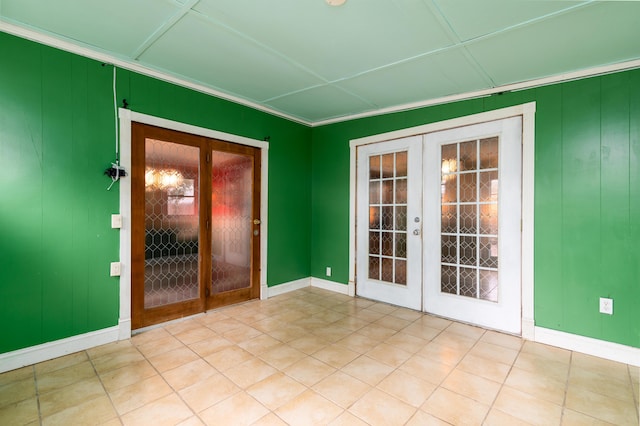 doorway with ornamental molding, light tile patterned floors, and french doors