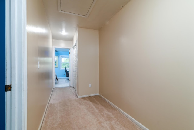 hallway with light colored carpet