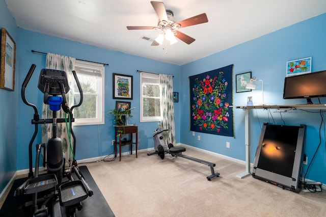 workout room with ceiling fan and light colored carpet