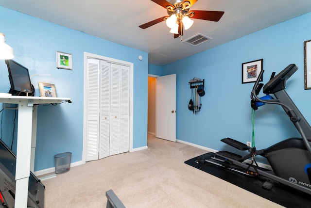 workout area with light carpet and ceiling fan