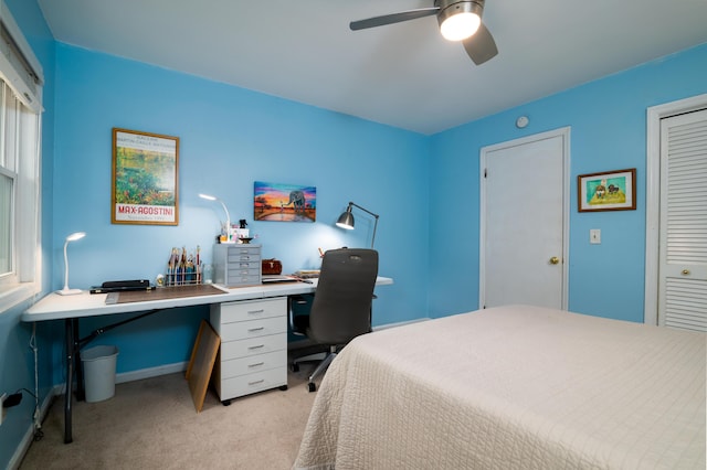 carpeted bedroom featuring a closet and ceiling fan