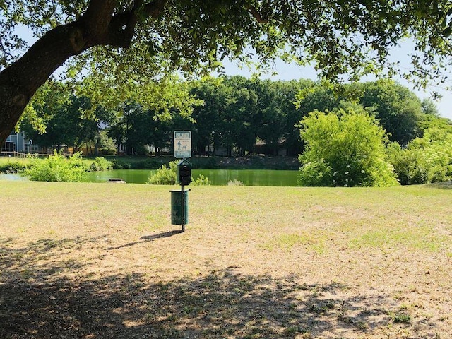 view of community with a water view and a yard