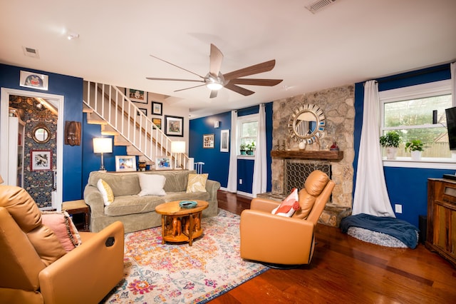 living room featuring hardwood / wood-style flooring and ceiling fan