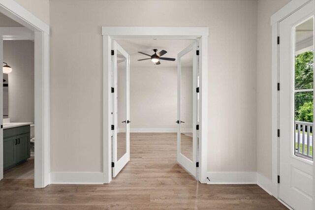 1577 Periwinkle Dr, Mount Pleasant, SC 29466 - hallway with french doors, light wood-style flooring, and baseboards
