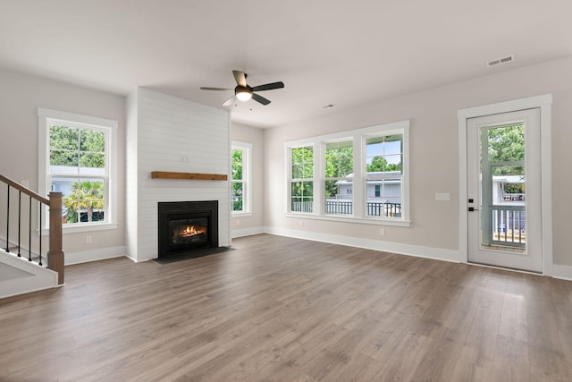 1577 Periwinkle Dr, Mount Pleasant, SC 29466 - unfurnished living room with ceiling fan, wood finished floors, baseboards, a fireplace, and stairs