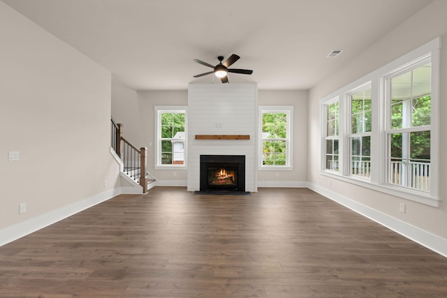 1577 Periwinkle Dr, Mount Pleasant, SC 29466 - unfurnished living room with ceiling fan, dark wood finished floors, a fireplace, baseboards, and stairs