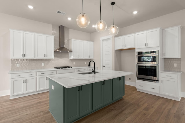 1577 Periwinkle Dr, Mount Pleasant, SC 29466 - kitchen with a sink, wall chimney exhaust hood, white cabinetry, stainless steel double oven, and light wood-style flooring