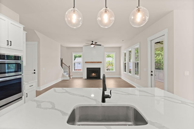 1577 Periwinkle Dr, Mount Pleasant, SC 29466 - kitchen with a sink, double oven, ceiling fan, a fireplace, and decorative light fixtures