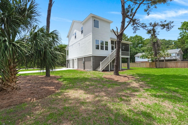 1577 Periwinkle Dr, Mount Pleasant, SC 29466 - back of house with a sunroom, an attached garage, stairway, and driveway