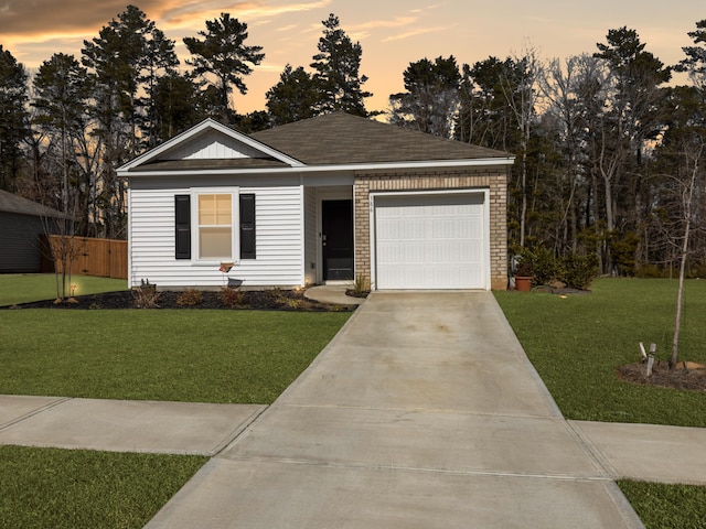 view of front facade with a garage and a yard