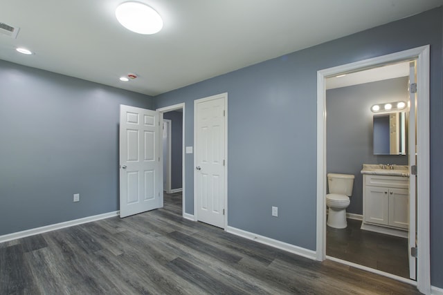 227 Grace St, Walterboro, SC 29488 - unfurnished bedroom featuring dark wood-type flooring, ensuite bath, and recessed lighting