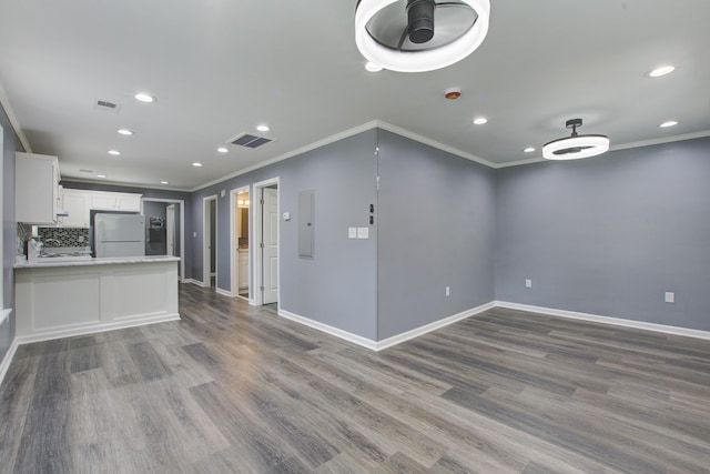 227 Grace St, Walterboro, SC 29488 - kitchen featuring freestanding refrigerator, crown molding, recessed lighting, white cabinets, and wood finished floors