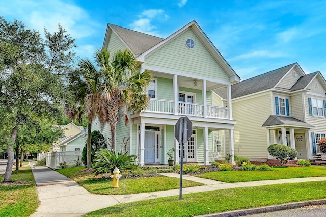 view of front of home with a balcony, a ceiling fan, and covered porch