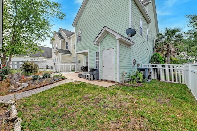 rear view of property featuring a patio and central AC unit
