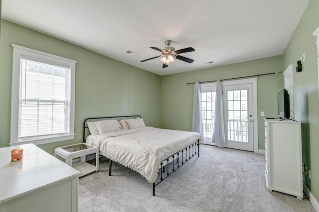 bedroom with light colored carpet, access to outside, ceiling fan, and baseboards