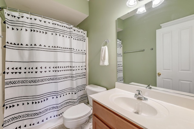 bathroom with vanity, toilet, and curtained shower