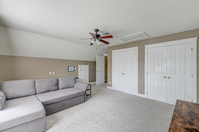 carpeted living room featuring a ceiling fan, lofted ceiling, and baseboards