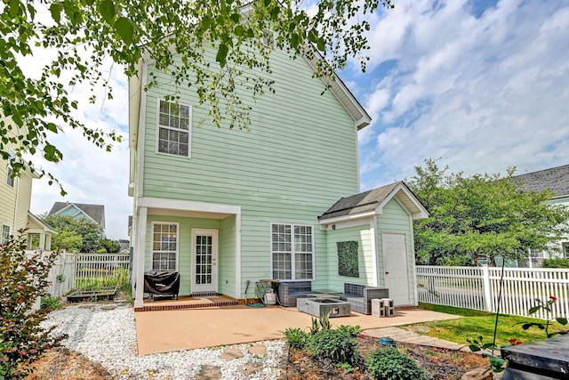 rear view of house with a patio and a fenced backyard