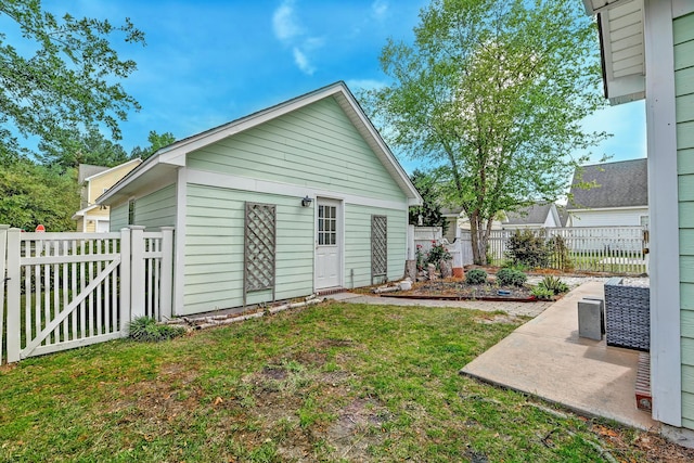 rear view of property with a patio and a gate