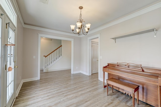 entrance foyer featuring stairs, a chandelier, light wood finished floors, crown molding, and baseboards